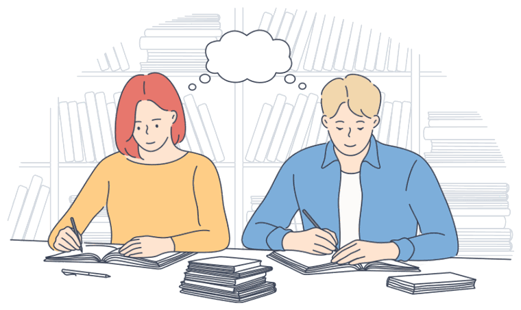 Two students sitting side by side at a library table, writing in open notebooks with stacks of books and a wall of bookshelves behind them.